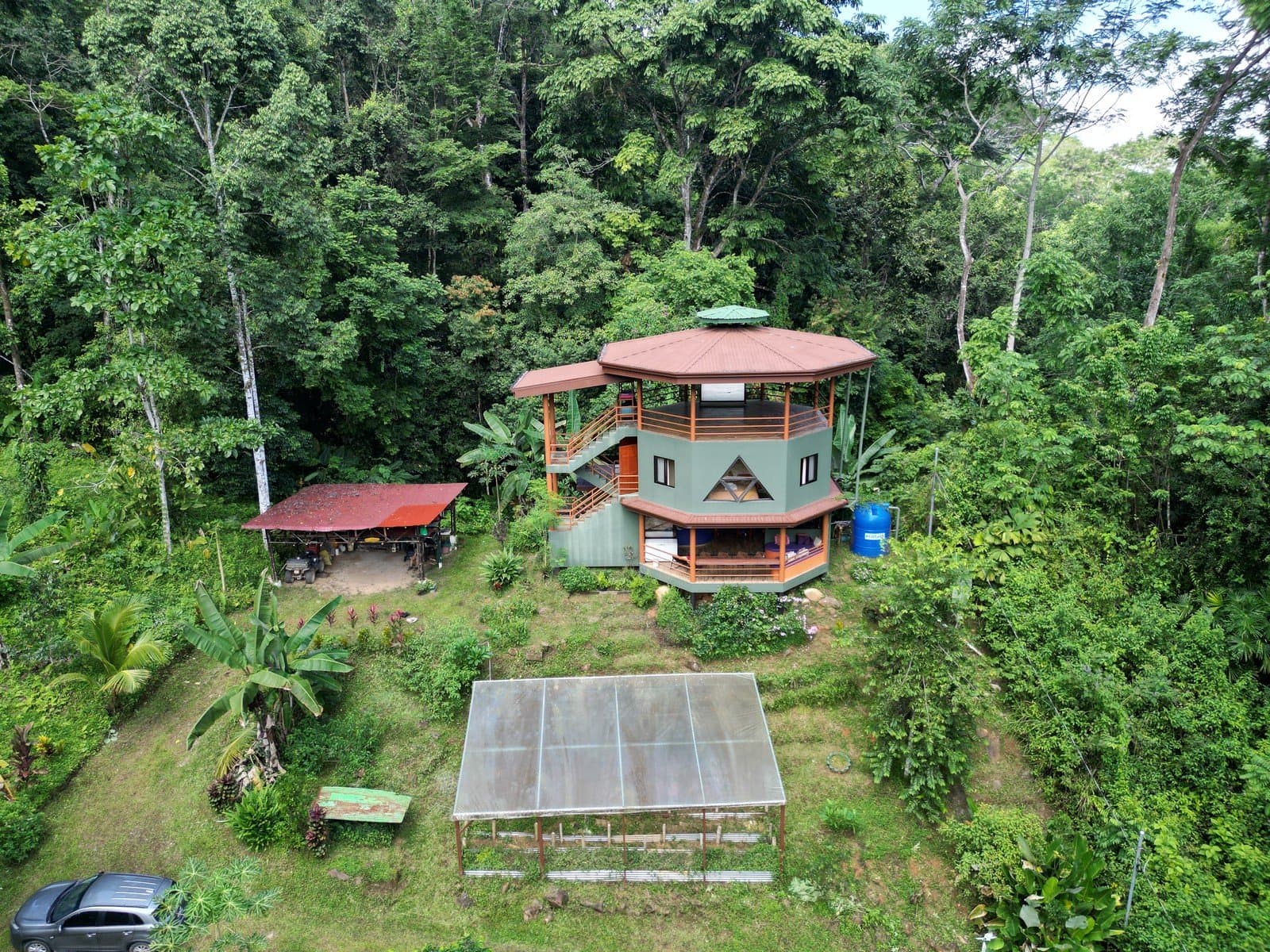 2.94 ACRES – 2 Bedroom Octagonal Home with Waterfall Views, Three 1-Bedroom Guest Cabins, Fruit Forest, river and Yoga Deck!